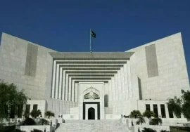 Front view of the Supreme Court of Pakistan building under a clear blue sky.