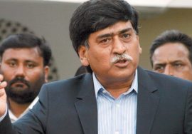 Afaq Ahmed, chairman of MQM-H, speaking to the media with supporters standing behind him.