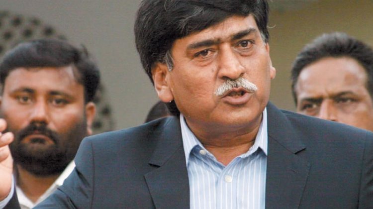 Afaq Ahmed, chairman of MQM-H, speaking to the media with supporters standing behind him.