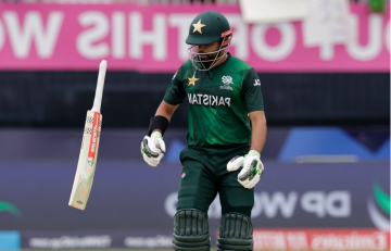 Babar Azam looking disappointed as his cricket bat slips from his hand after getting out during a match.