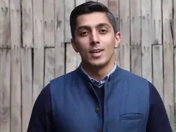 Portrait of Ali Tareen, former owner of the Multan Sultans PSL franchise, standing in front of a wooden background.