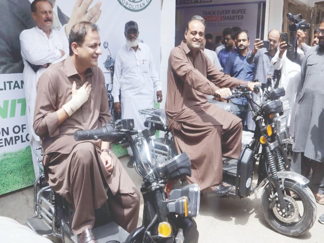 Karachi Mayor and officials testing new electric bikes during KMC e-bike launch ceremony in Karachi.