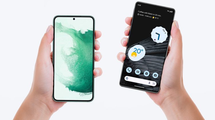 Two hands holding two modern Android smartphones, each displaying different home screens and app layouts.