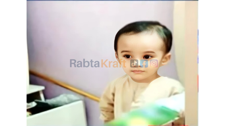 “Cute toddler with big expressive eyes wearing a light cream outfit, standing indoors near a soft pastel-colored background.”