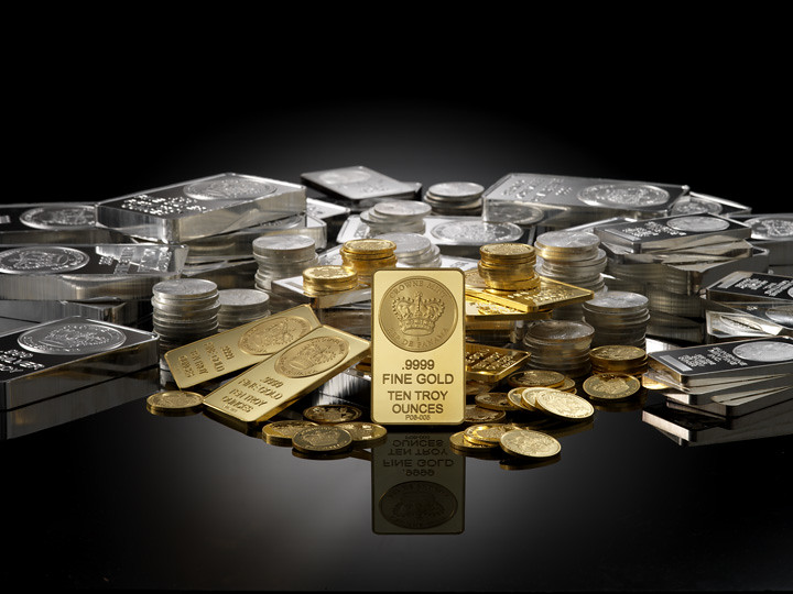 “Gold bars, silver bars, and gold coins displayed together, representing precious metal investment and bullion market.”