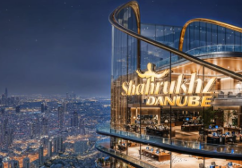 “Shah Rukh Khan Danube Tower overlooking Dubai skyline at night — luxury high-rise building on Sheikh Zayed Road.”