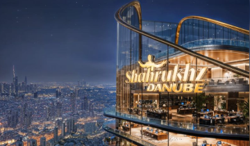 “Shah Rukh Khan Danube Tower overlooking Dubai skyline at night — luxury high-rise building on Sheikh Zayed Road.”
