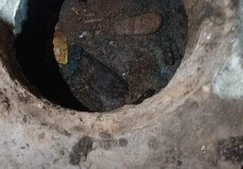 An open sewer manhole on a street in Karachi, posing a serious danger to pedestrians and children