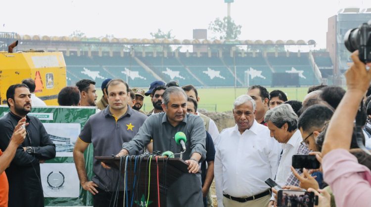“PCB officials addressing media during stadium renovation briefing at a cricket ground, surrounded by press and staff.”