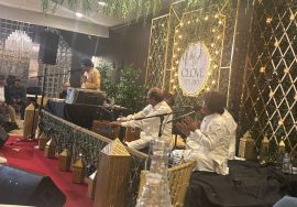 "Qawwali performance at Clove Studio with musicians singing live on stage in a decorated indoor event setup."