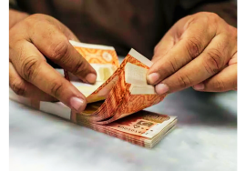 Government employees counting extra salary cash in Pakistan