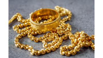 Gold jewelry including ring and chains displayed after gold price decrease in Pakistan