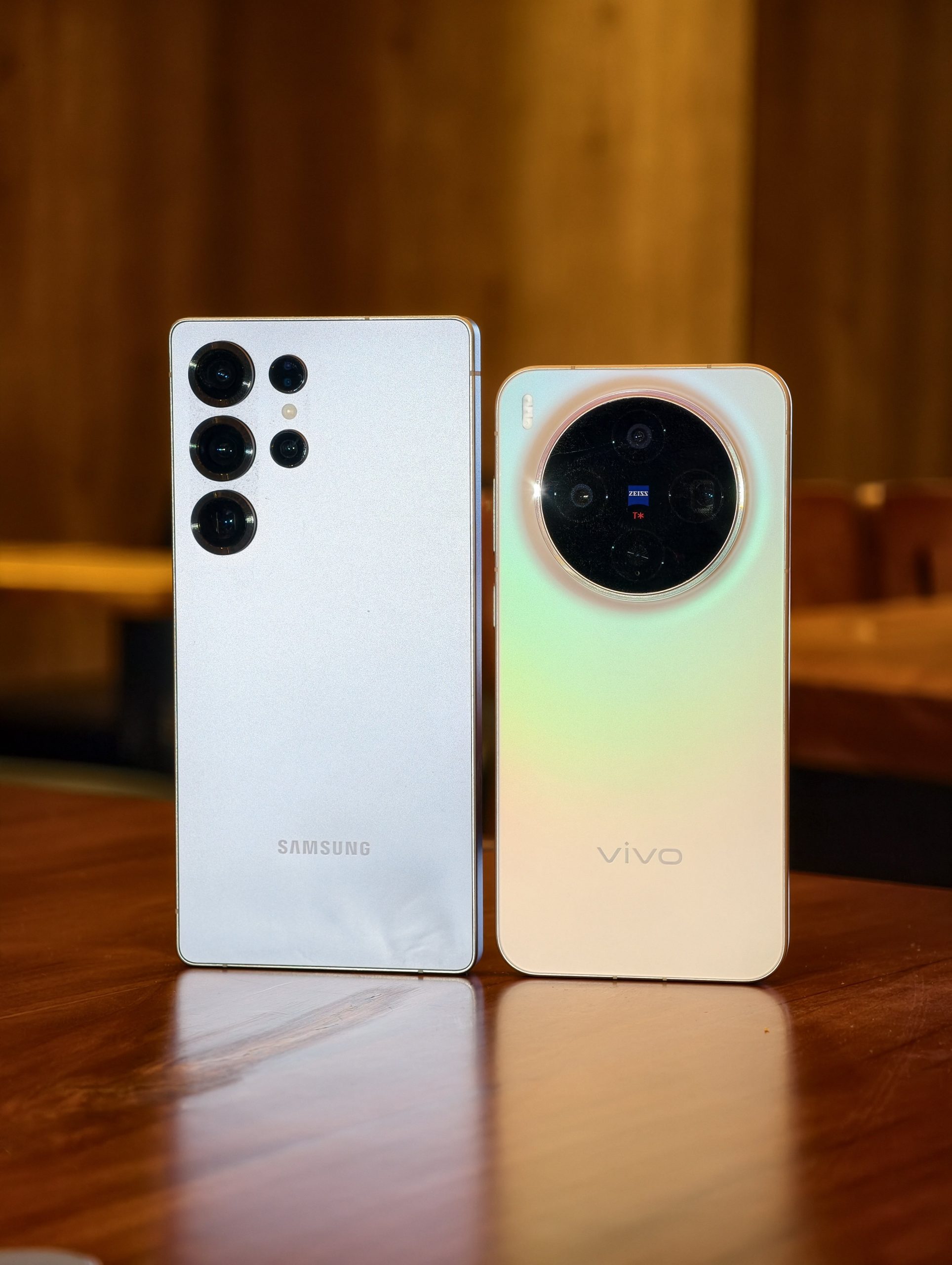 Samsung and Vivo smartphones placed side by side showcasing premium rear camera design and modern smartphone build